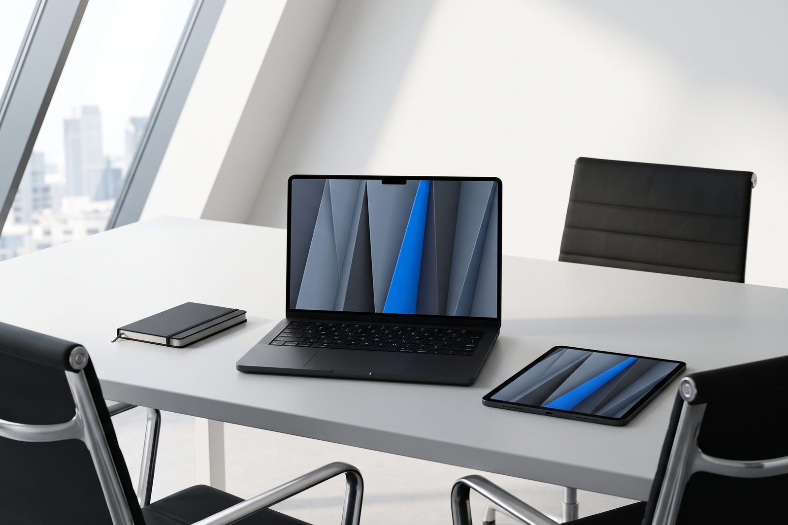 Glass-walled meeting room with a Space Black MacBook Pro and iPad Pro set out before a fleet review