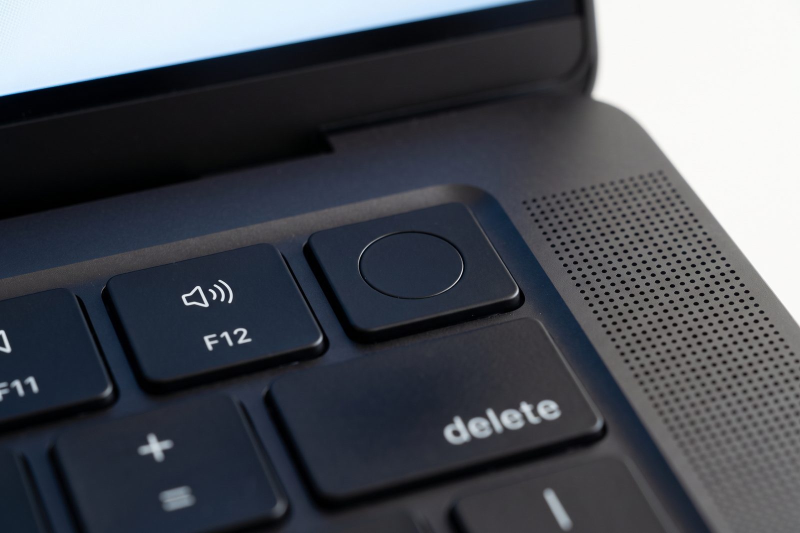 Macro of the Touch ID key on a Space Black MacBook Pro keyboard, hardware-level security